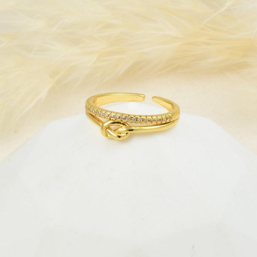 Anillo ajustable con nudo en baño de rodio dorado | Feral